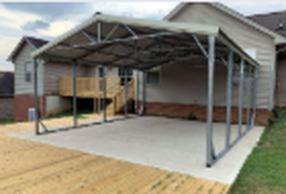 Premier steel carport on a concrete pad beside a house