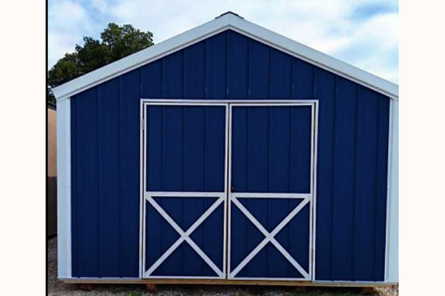 Navy blue wood shed with white double doors
