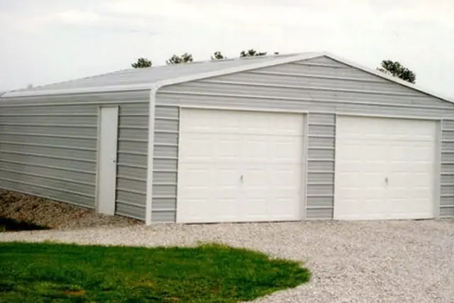 Steel garage with two roll-up doors in gray